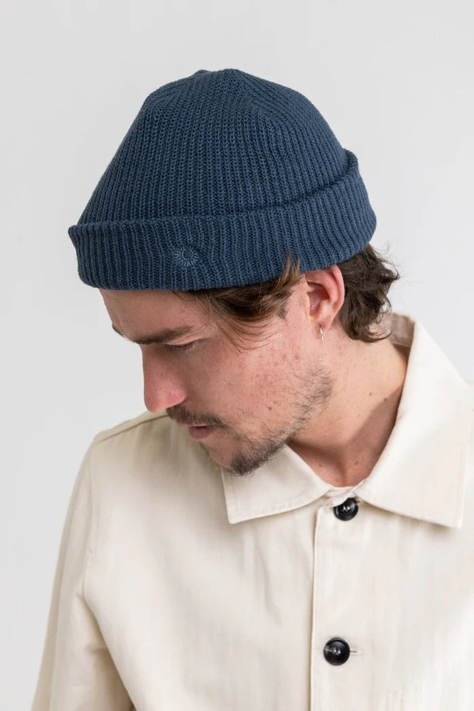 A man wearing the Worn Navy Classic Watch Beanie by Rhythm