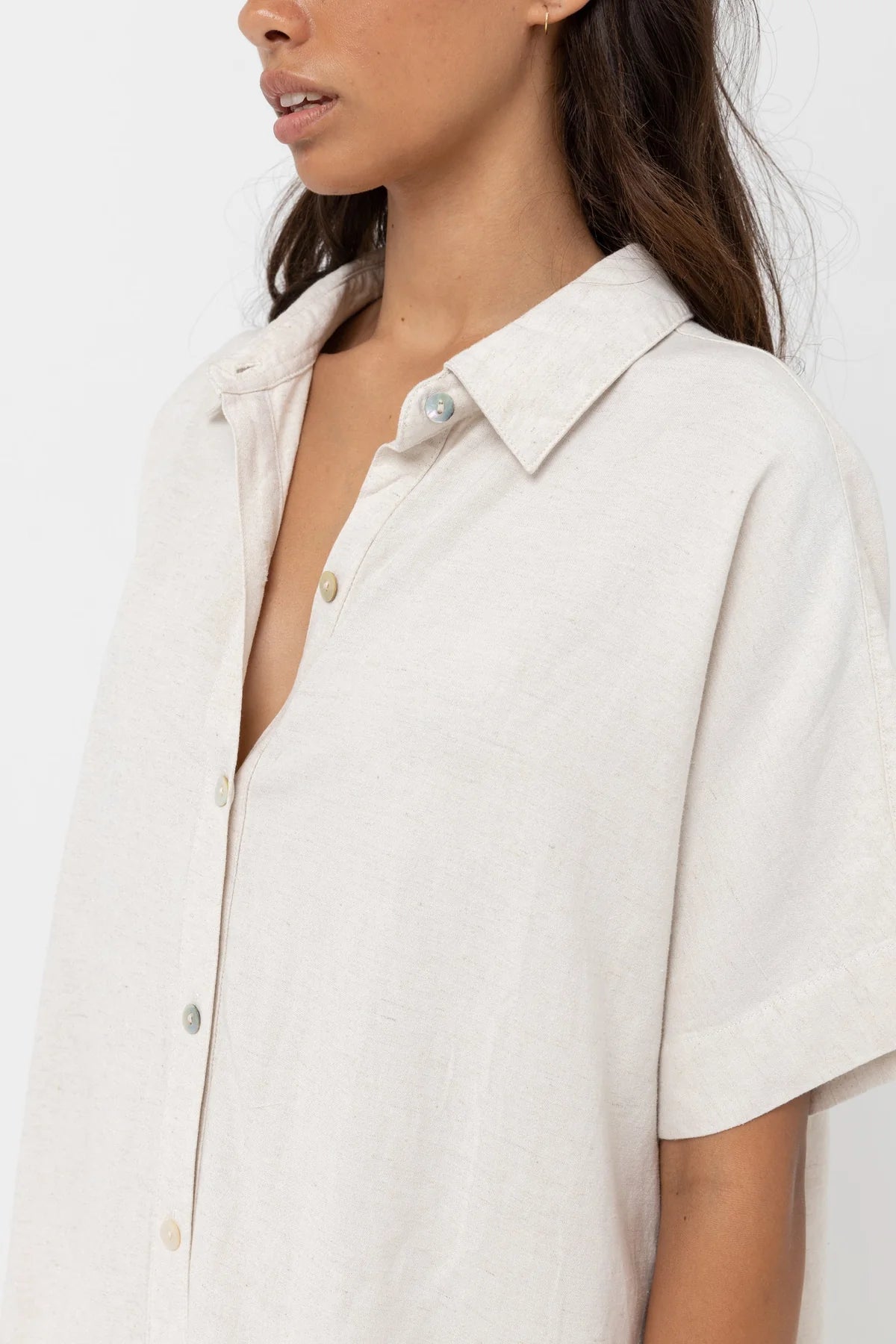 Close up front view of woman wearing an oat color oversized short sleeve shirt dress