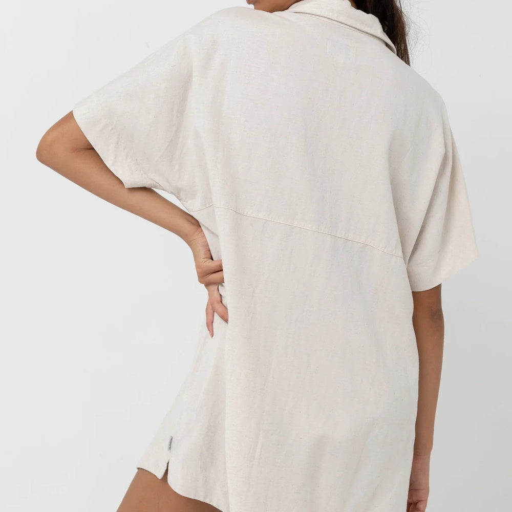 
                      
                        Back view of woman wearing an oat color oversized short sleeve shirt dress
                      
                    