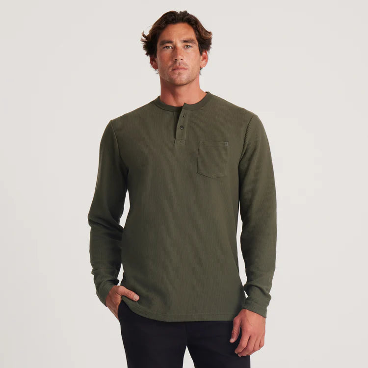 Front view of a man wearing the Military Green Companion Long Sleeve Thermal Henley by the brand Roark