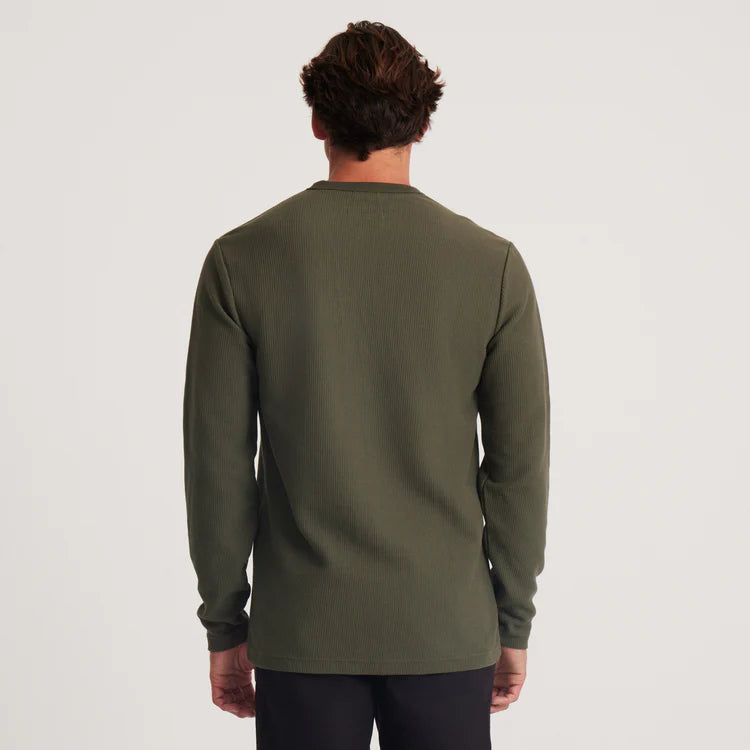 Back view of a man wearing the Military Green Companion Long Sleeve Thermal Henley by the brand Roark