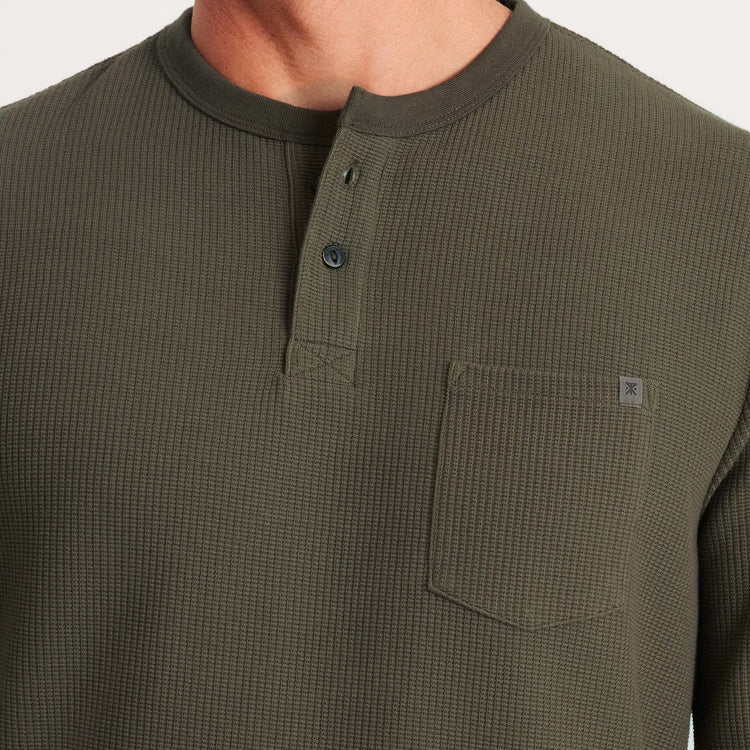 
                      
                        Front pocket and henley neckline detail on the Military Green Companion Long Sleeve Thermal Henley by the brand Roark
                      
                    