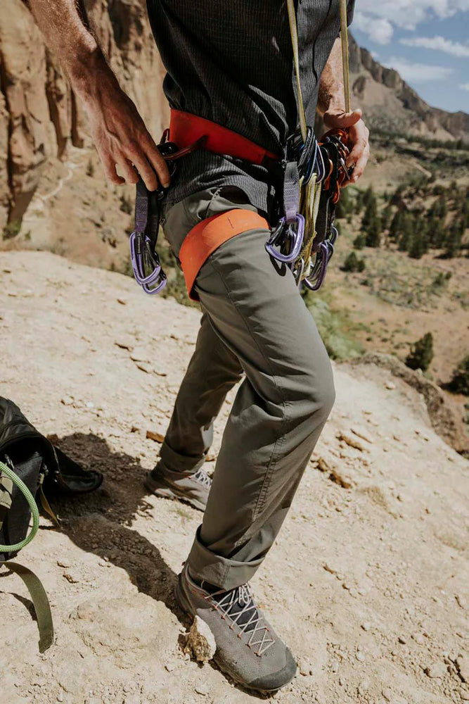 A man wearing the Campover Pants by Roark while mountain climbing