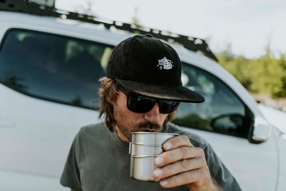 
                      
                        A man wearing the Black Wolf Campover Strapback Hat by Roark
                      
                    