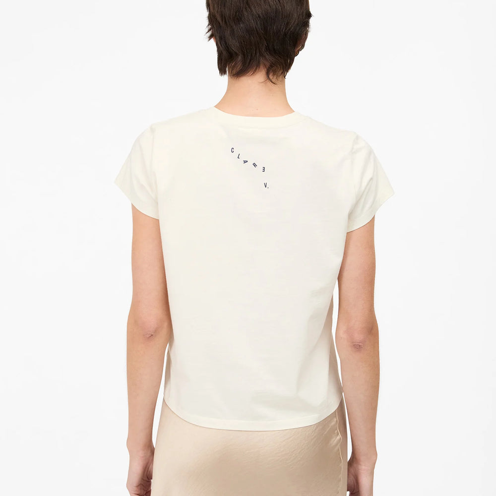 Person wearing a white t-shirt by Clare V. 