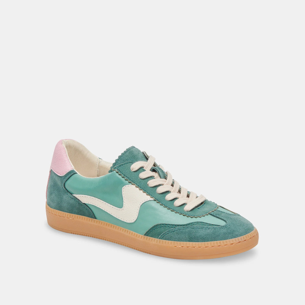 
                      
                        Green suede women's low top sneakers with pink accents and textured uppers
                      
                    