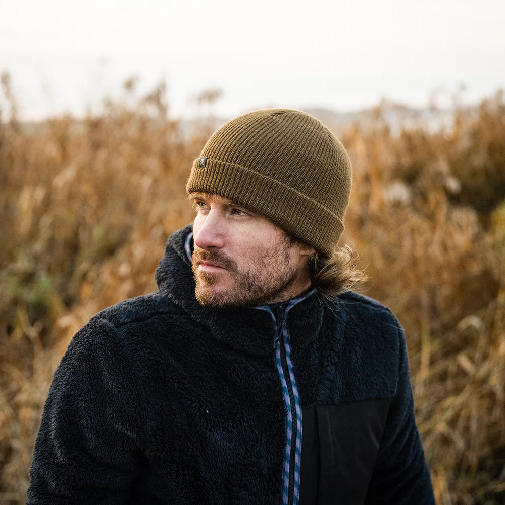 
                      
                        A man wearing a green beanie from Roark
                      
                    