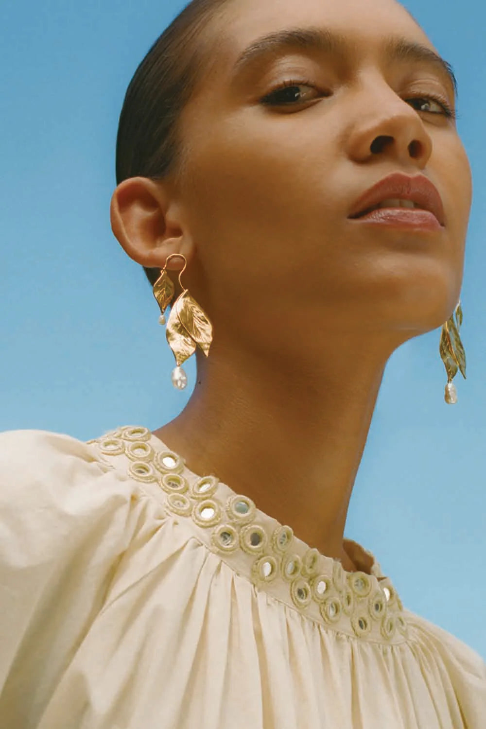 Woman wearing Chan Luu's Falling Leaf White Pearl Earrings