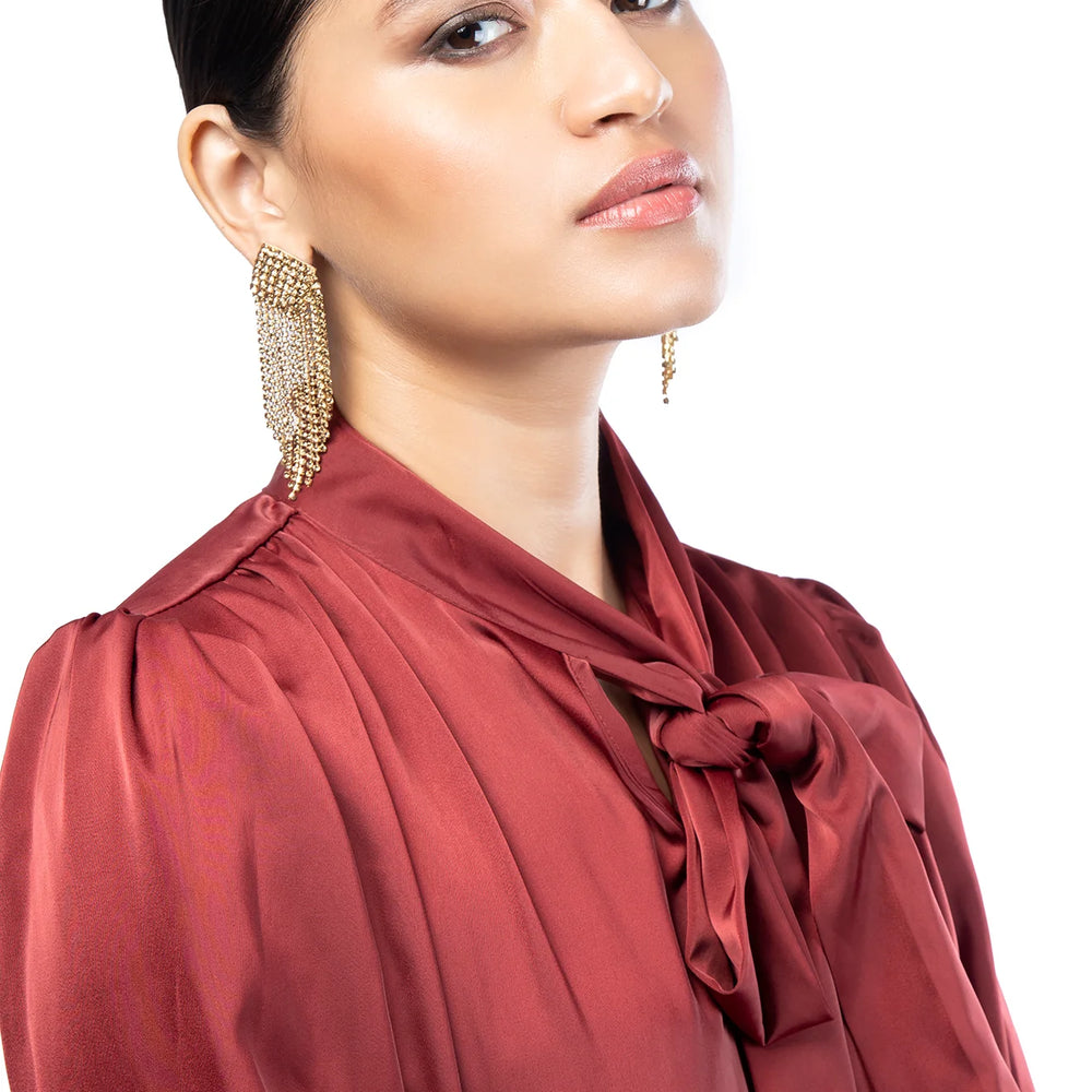 
                      
                        A woman wearing the Gold Niomi Earrings by Deepa Gurnani
                      
                    