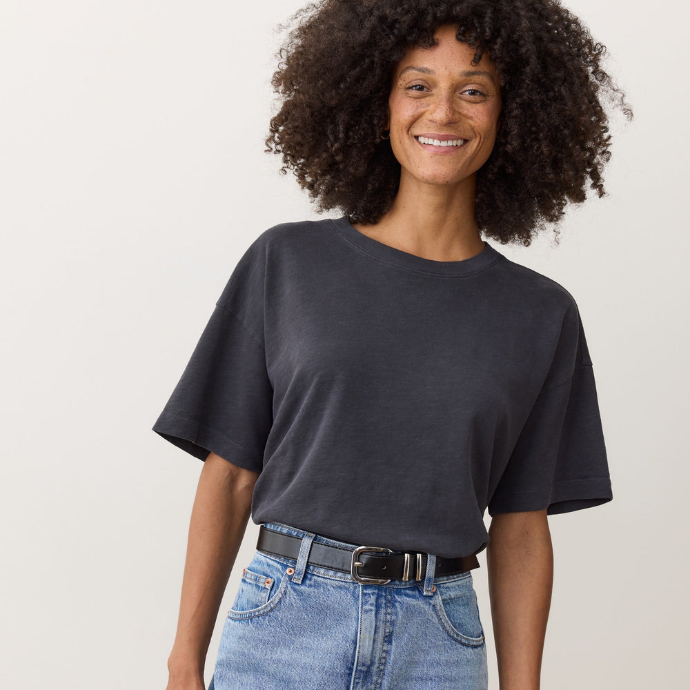 A woman wearing the Marine Layer Sadie Vintage Slub Oversized Tee in the the color black
