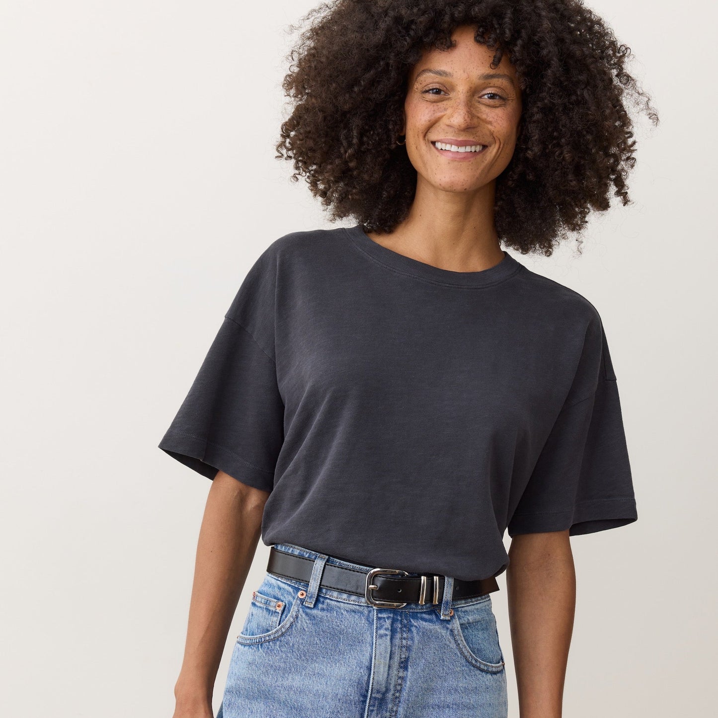 A woman wearing the Marine Layer Sadie Vintage Slub Oversized Tee in the the color black