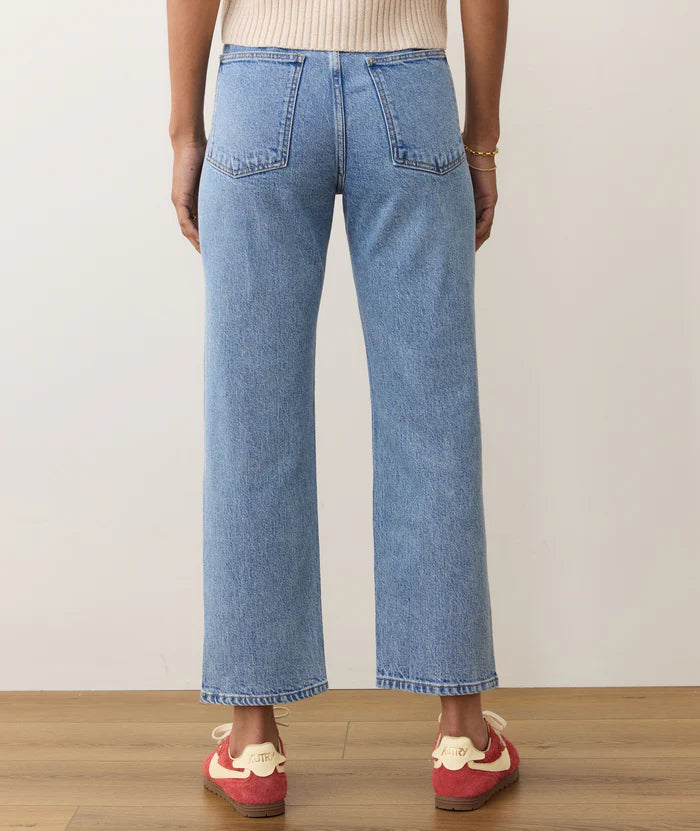
                      
                        Person wearing vintage wash straight leg blue jeans from Marine Layer. 
                      
                    