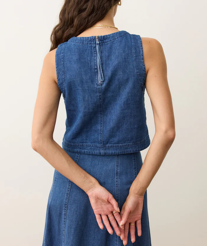 Woman wearing a blue denim Marine Layer top with matching skirt