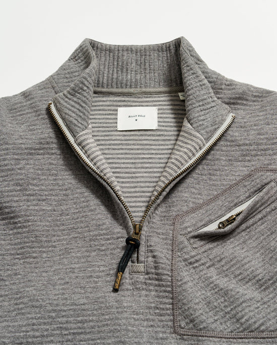 Close up of half zip neckline on a men's grey pullover