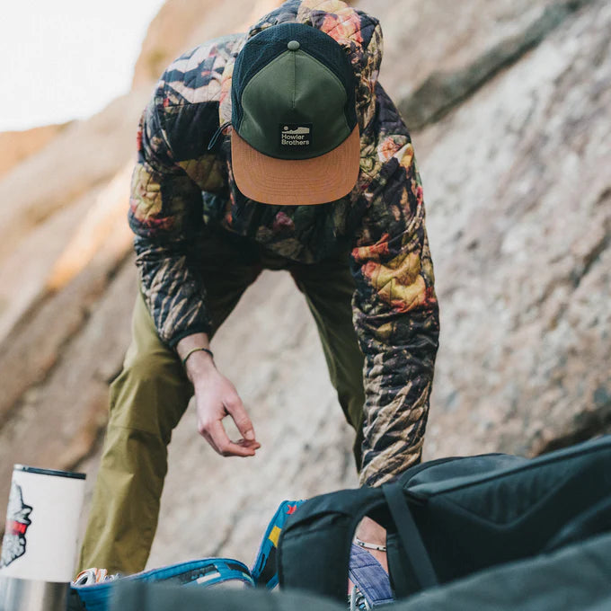 
                      
                        A man wearing the Aperture Tech Howler Arroyo Strapback Hat by Howler Bros
                      
                    