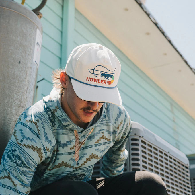 
                      
                        A man wearing the Skrimp Unstructured Snapback Hat by Howler Bros
                      
                    