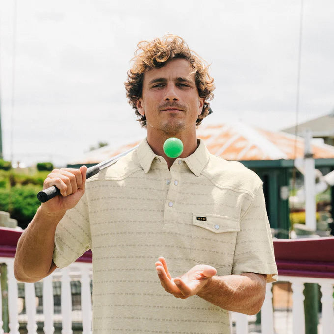 A man outside wearing the Chiba Jacquard Creme Ranchero Jacquard Polo by Howler Bros
