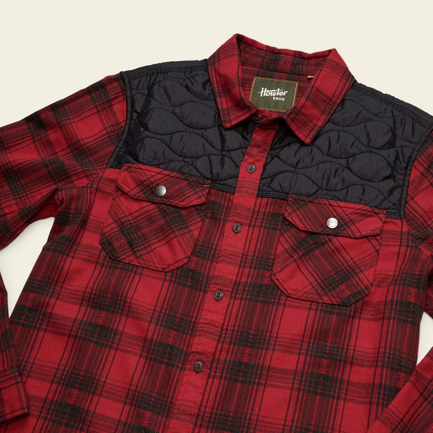 Red and black plaid shirt from Howler Bros with quilted black yoking and 2 chest pockets. 