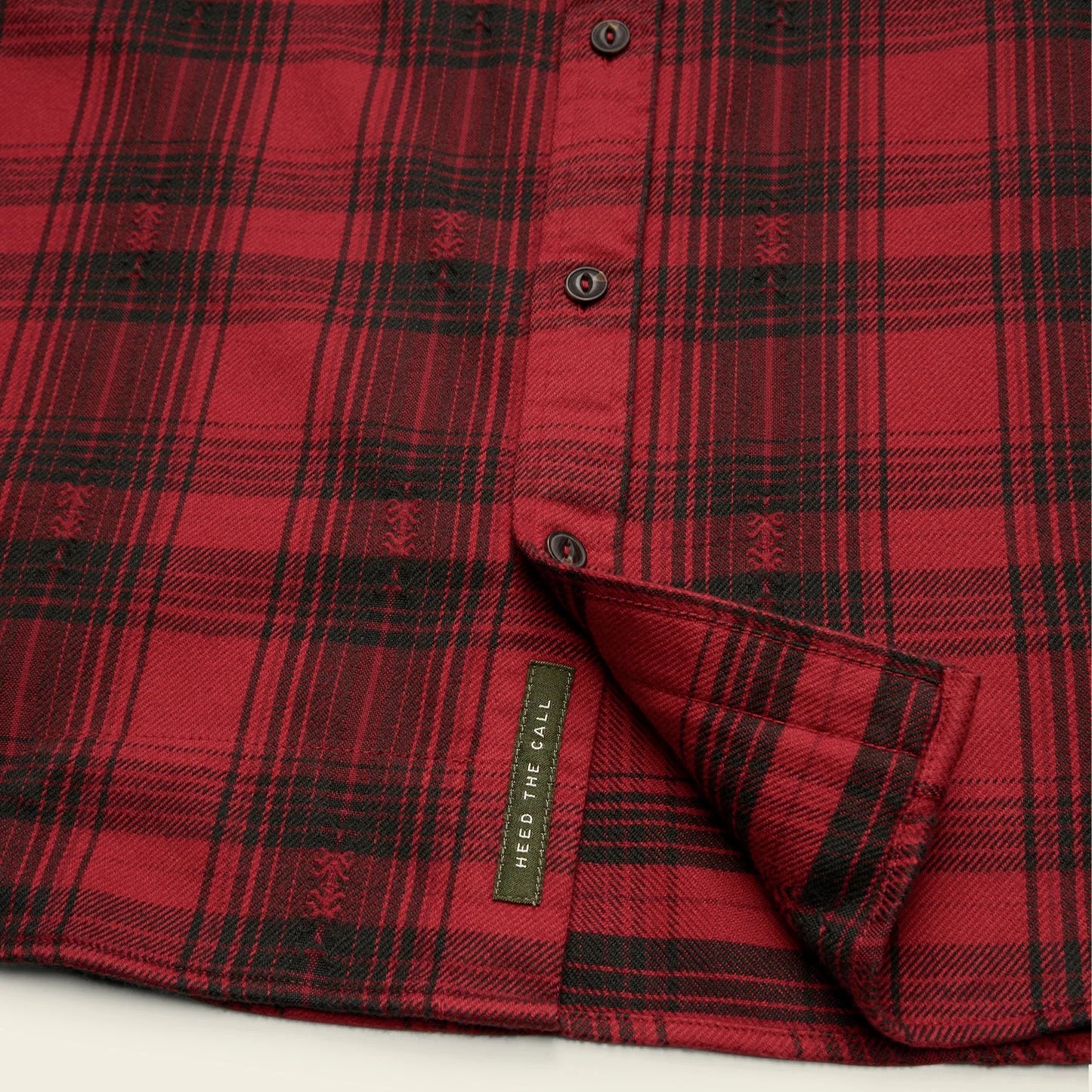Red plaid shirt with a Howler Bros 'Heed The Call' label near the bottom hem