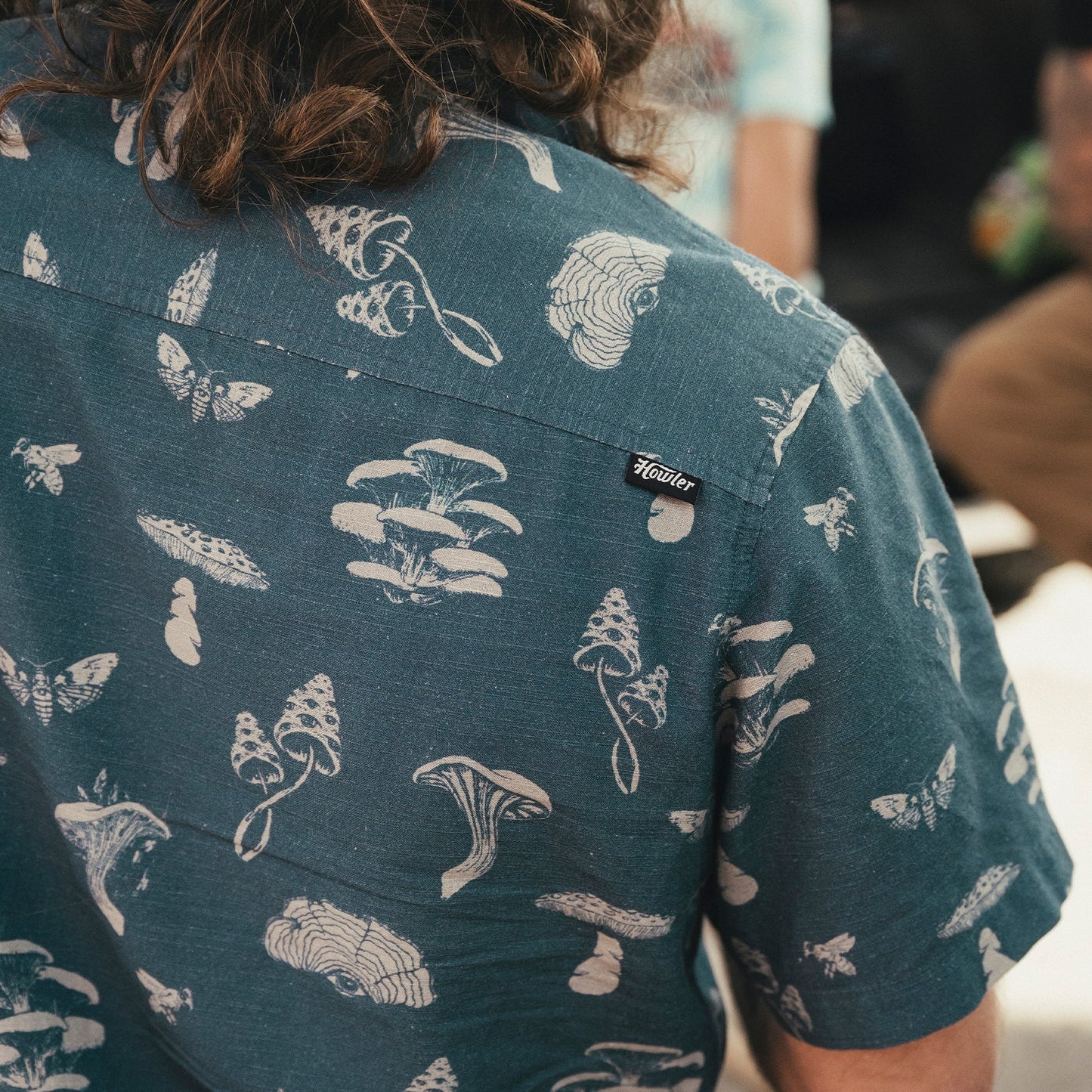 Man wearing the Floating Fungi Stargazer Monoloha Shirt by Howler Bros. 