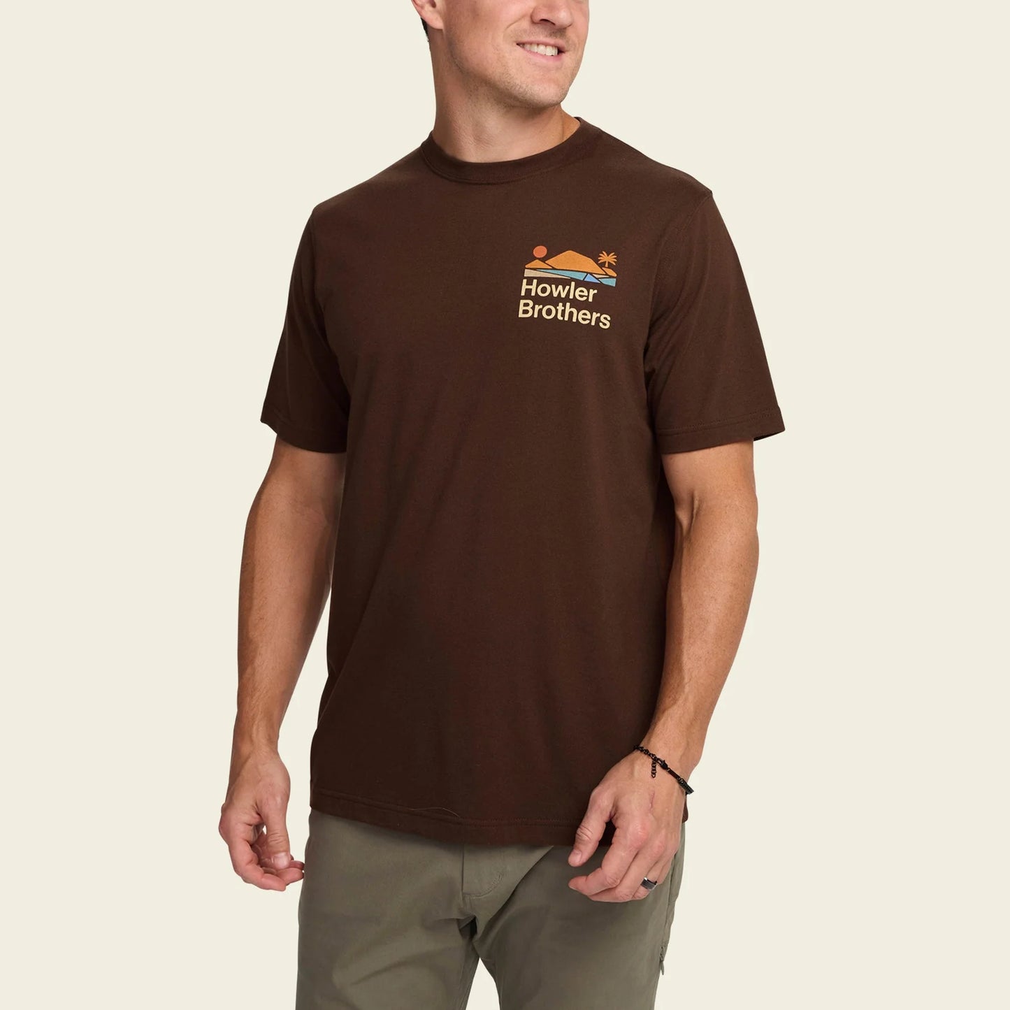 Man wearing a mahogany  t-shirt with 'Howler Brothers' logo 