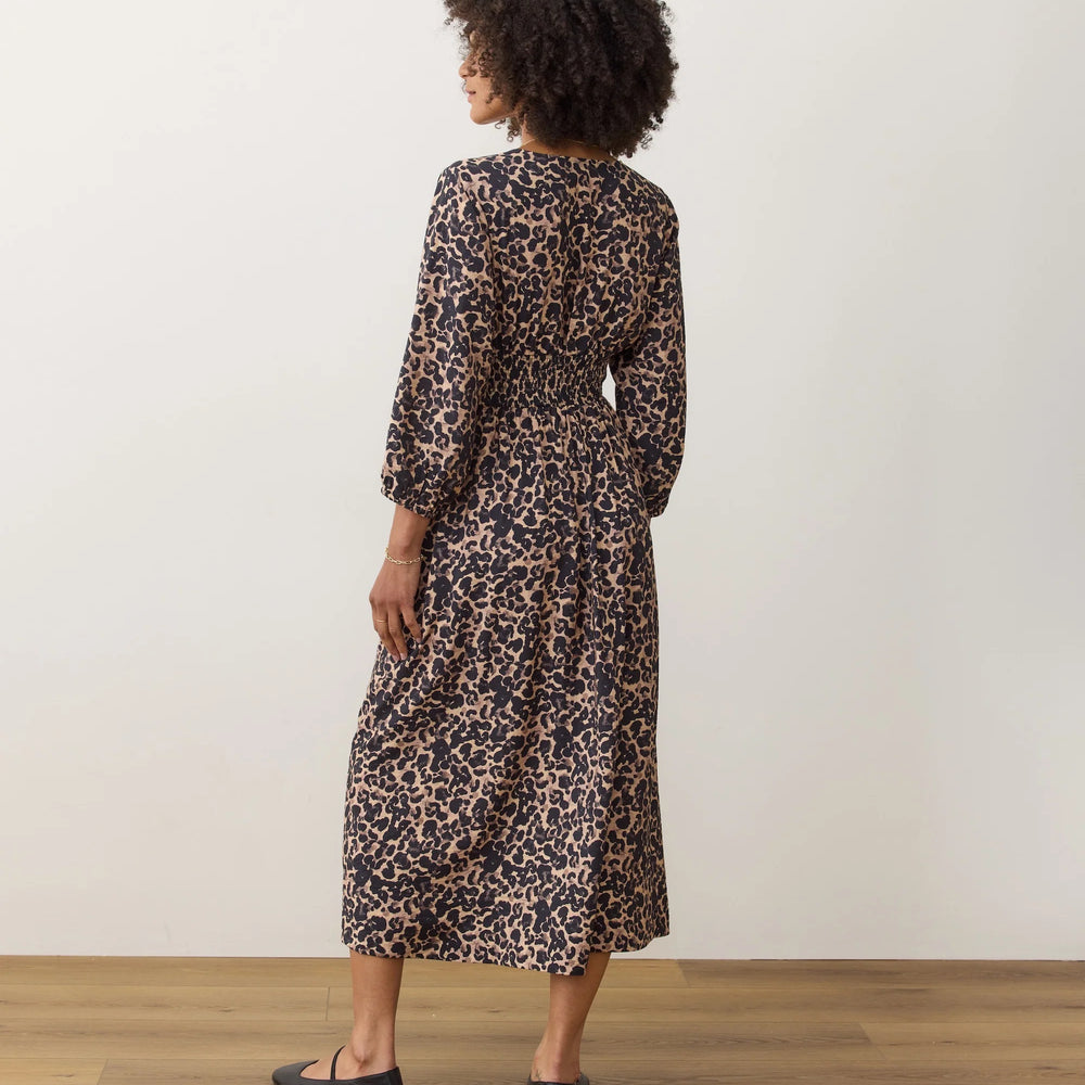 
                      
                        Woman wearing a leopard print dress with elbow length sleeves
                      
                    