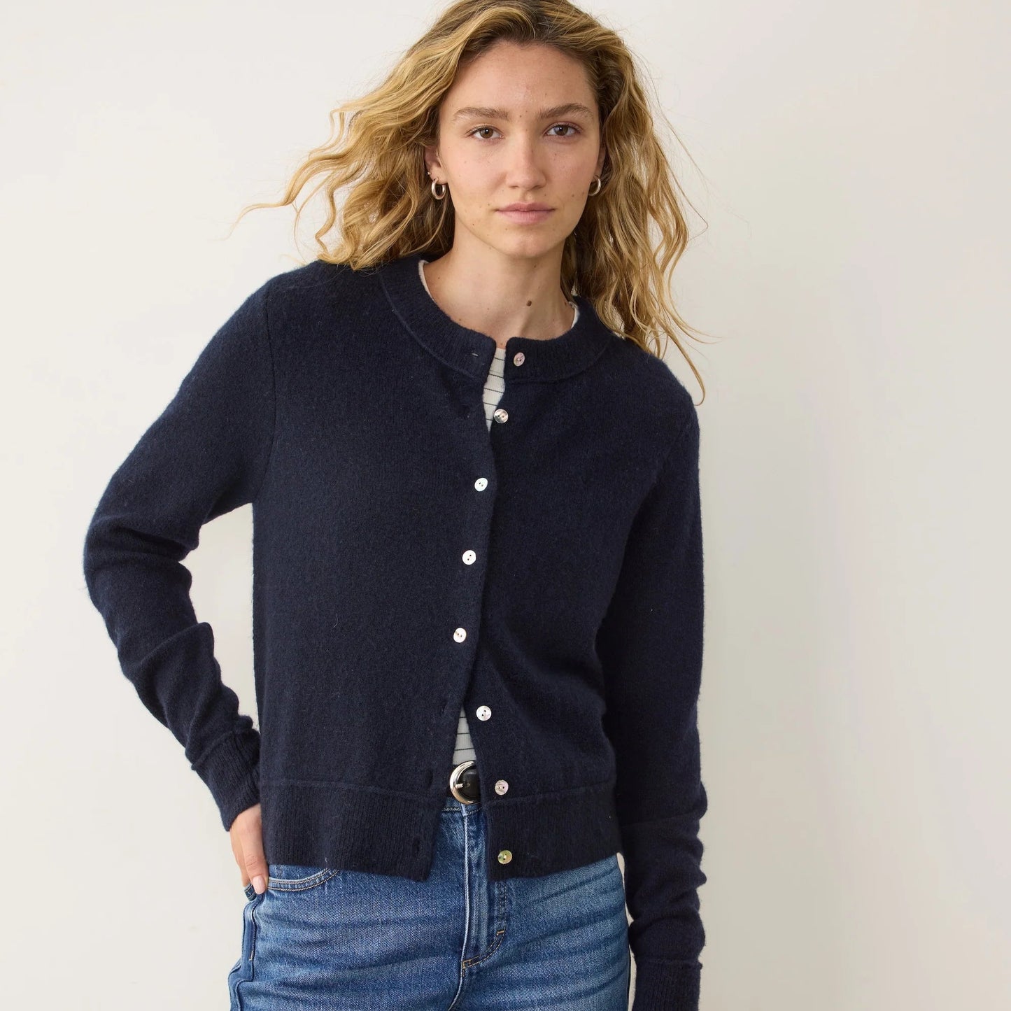 A woman wearing the Marine Layer Sausalito Cardigan in the color True Navy