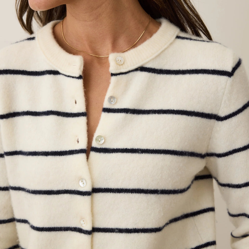 A woman wearing the Marine Layer Sausalito Cardigan in the color Harbour Stripe. 