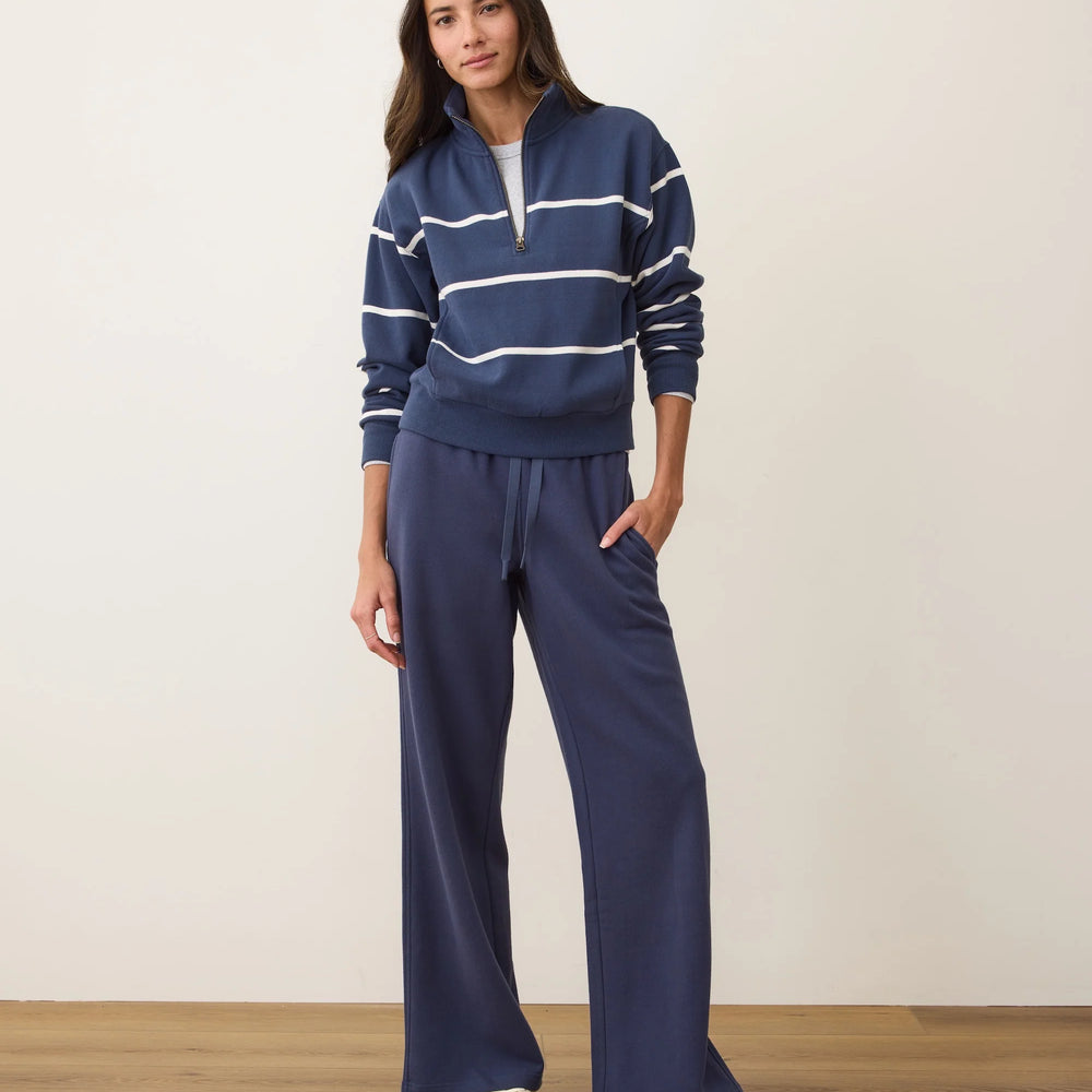 
                      
                        Woman wearing a navy striped sweater and wide-leg pants from Marine Layer
                      
                    