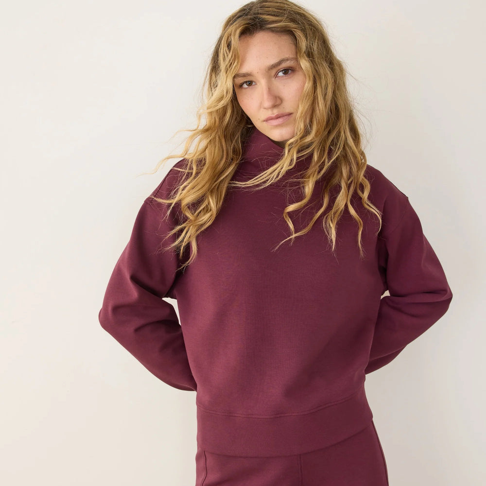 
                      
                        A woman wearing the Marine Layer Nova Mock Neck Sweatshirt in the color Fig
                      
                    