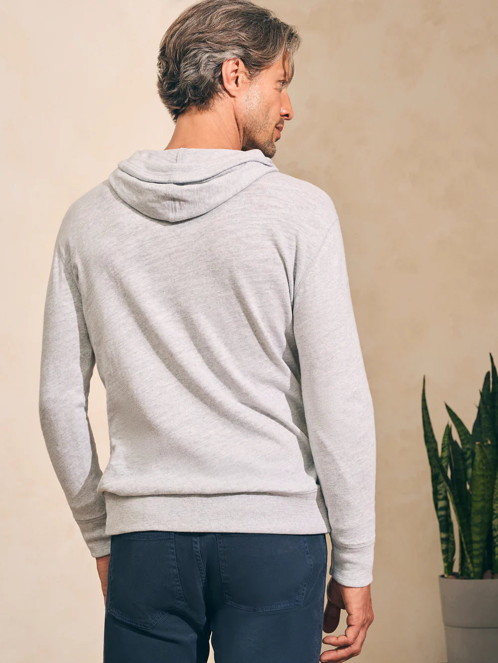 Back view of man wearing the Faherty Sunwashed Slub Hoodie in color Light Grey Heather