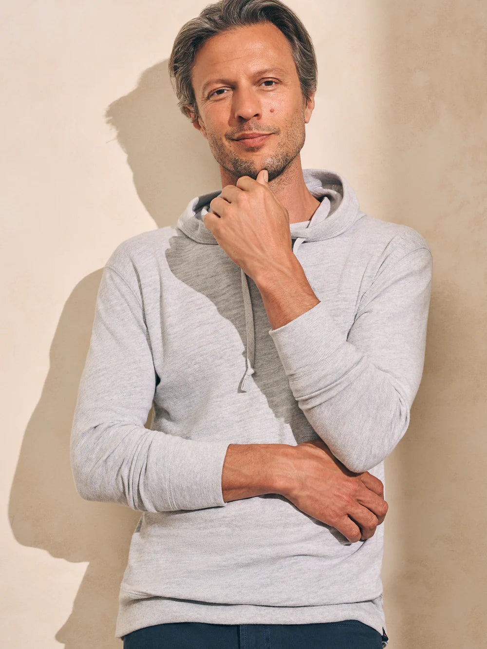 Front view of man wearing the Faherty Sunwashed Slub Hoodie in color Light Grey Heather