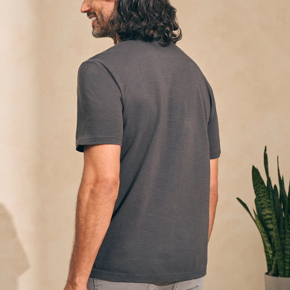 Back view of man wearing a washed black short sleeve t-shirt by Faherty
