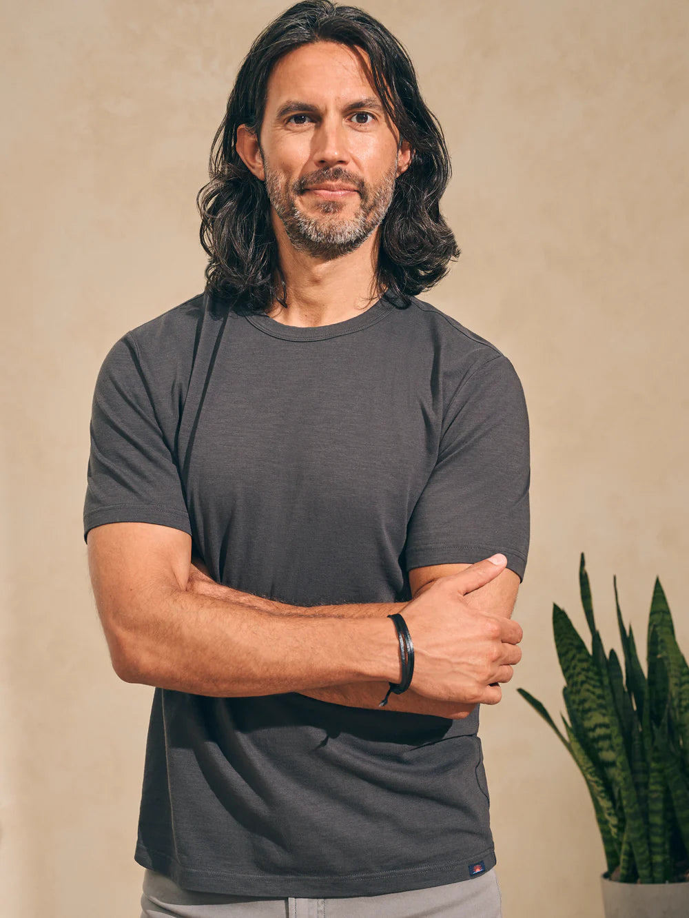 front view of man wearing a washed black short sleeve t-shirt by Faherty
