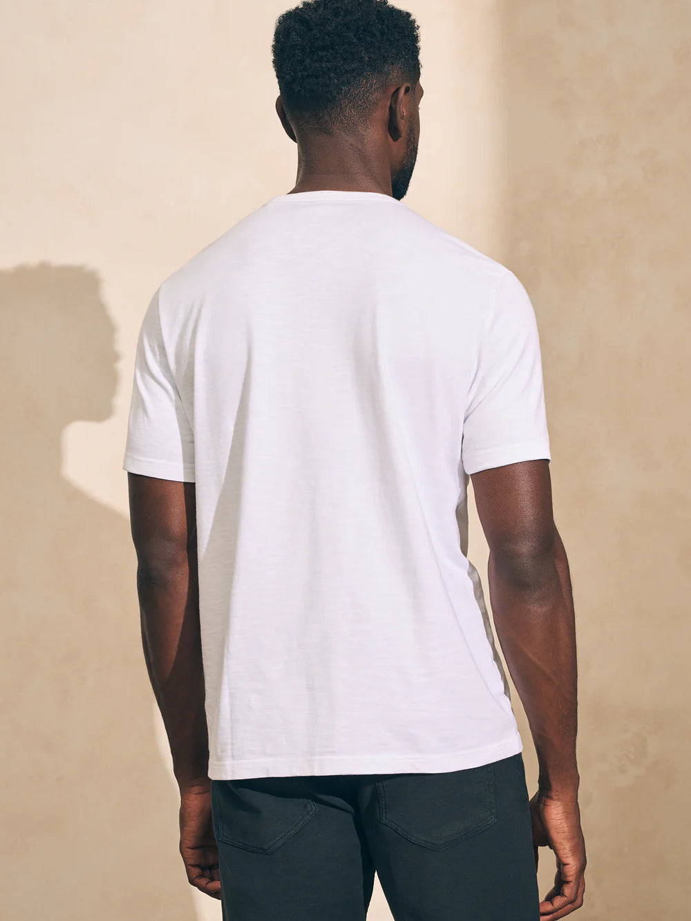 Back view of man wearing a white short sleeve t-shirt by Faherty