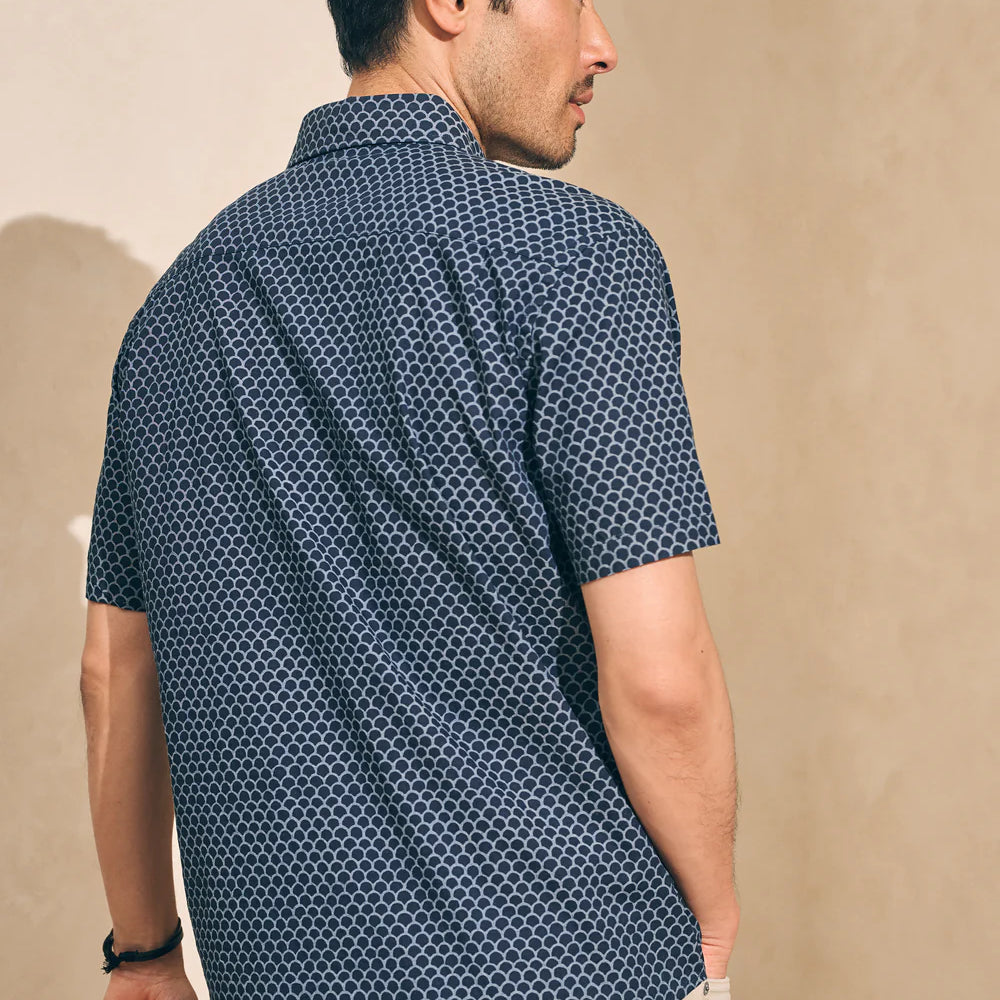 
                      
                        Back view of a man wearing a fishscale print short sleeve button up shirt by Faherty
                      
                    