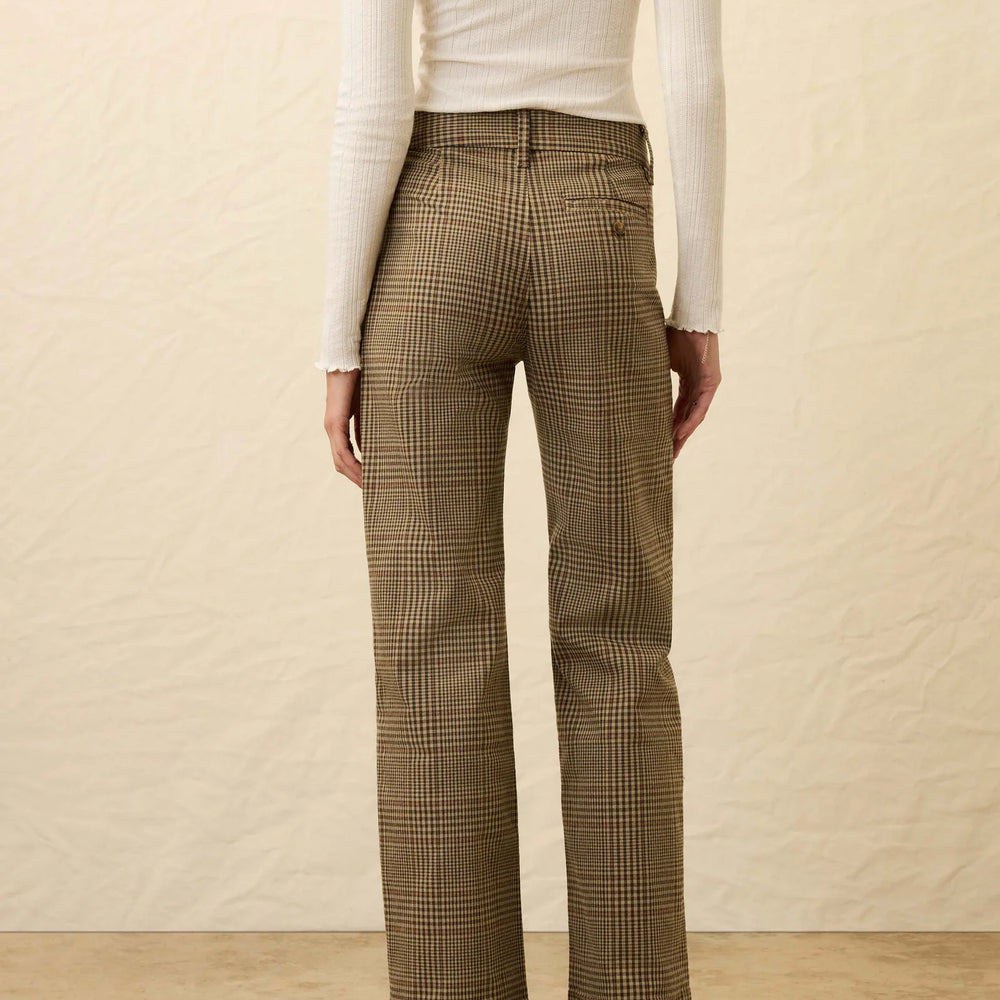 
                      
                        A woman wearing slim straight brown plaid pants from Faherty
                      
                    