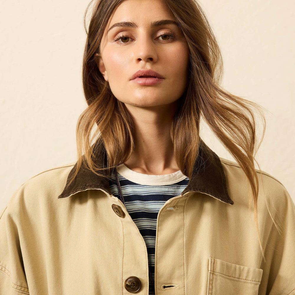 
                      
                        A woman wearing a khaki jacket from Faherty with a corduroy collar.
                      
                    