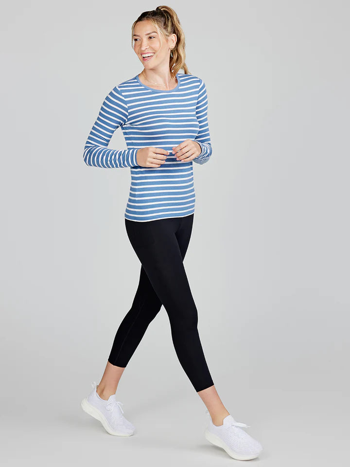 
                      
                        Woman walking while wearing the blue and white stripe Nola Long Sleeve T-shirt by tasc Performance
                      
                    