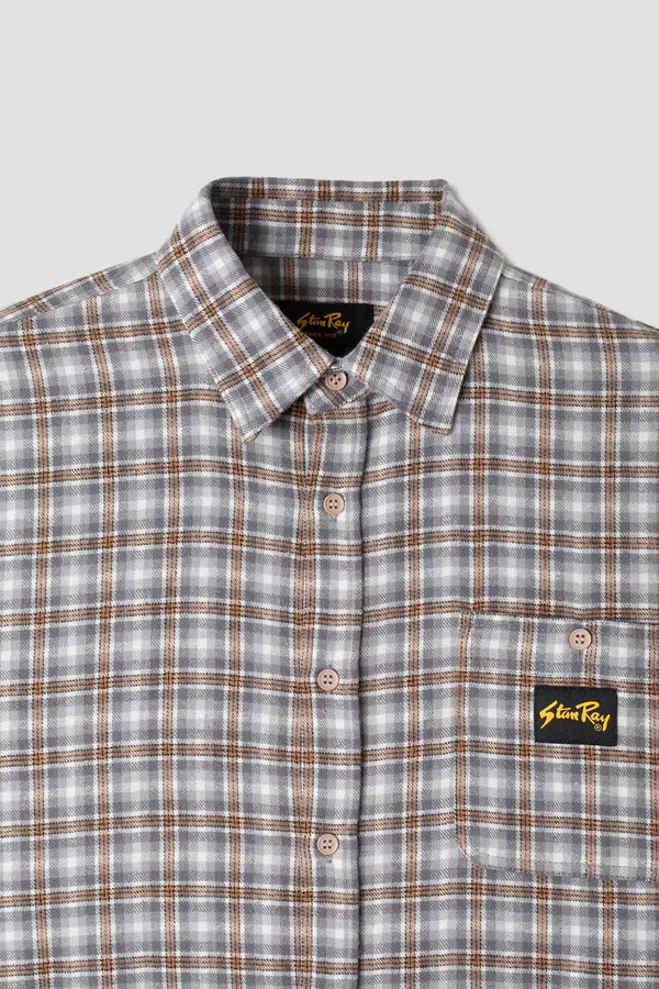 
                      
                        Front collar and pocket detail on the Grey Plaid Long Sleeve Flannel Shirt by the brand Stan Ray. 
                      
                    