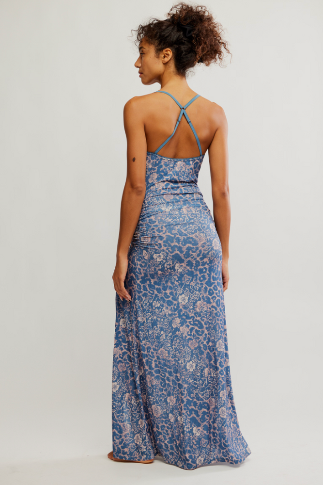 
                      
                        Woman wearing a blue animal print maxi slip dress by Free People
                      
                    