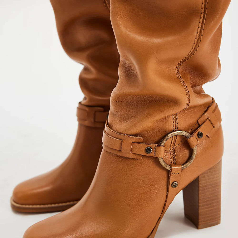 Tan leather heeled boots with metal hardware