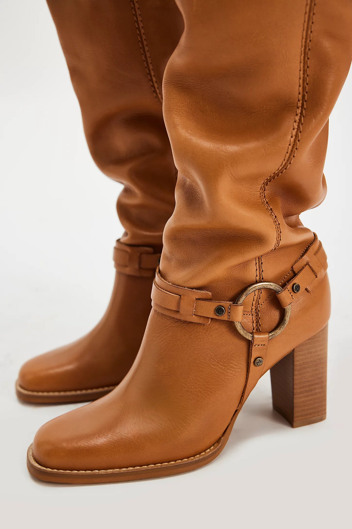 Tan leather heeled boots with metal hardware