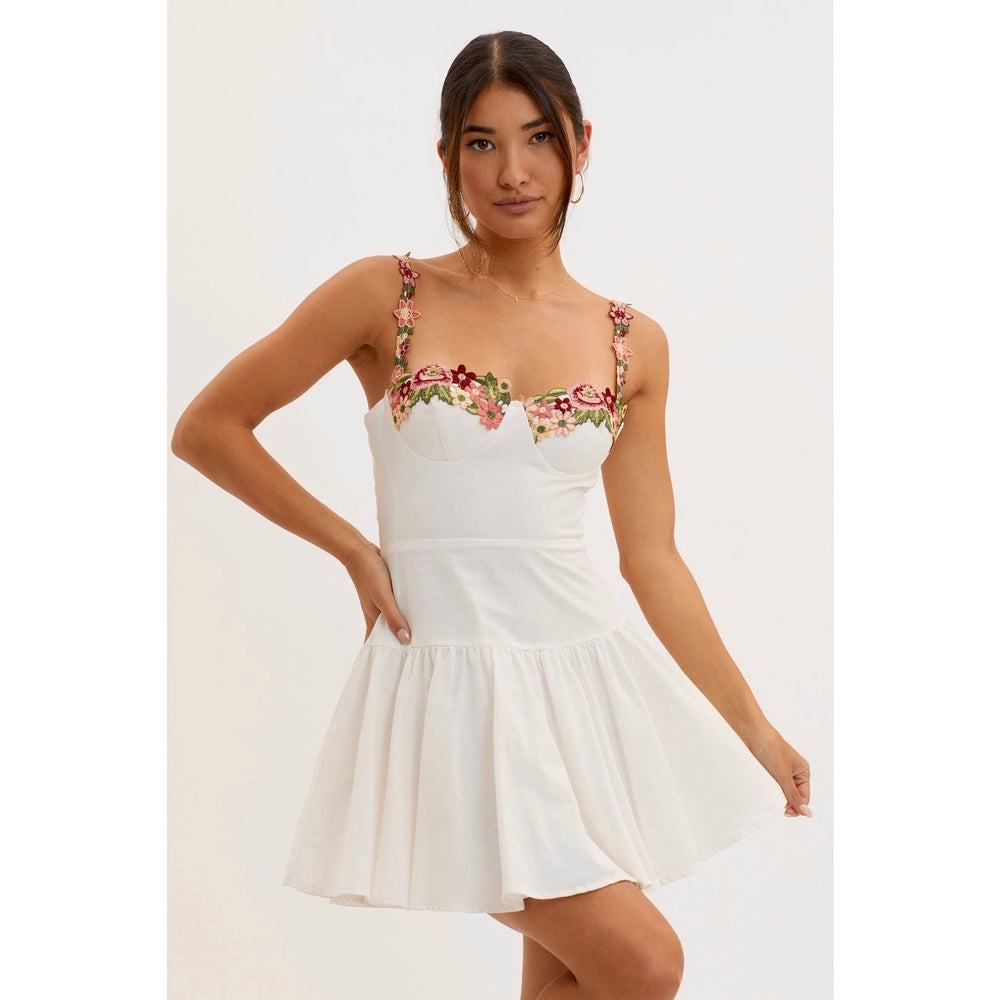 Enjoy sweet warm-weather style with this fully lined floral applique trim mini dress, available at Harbour Thread for your spring events. 