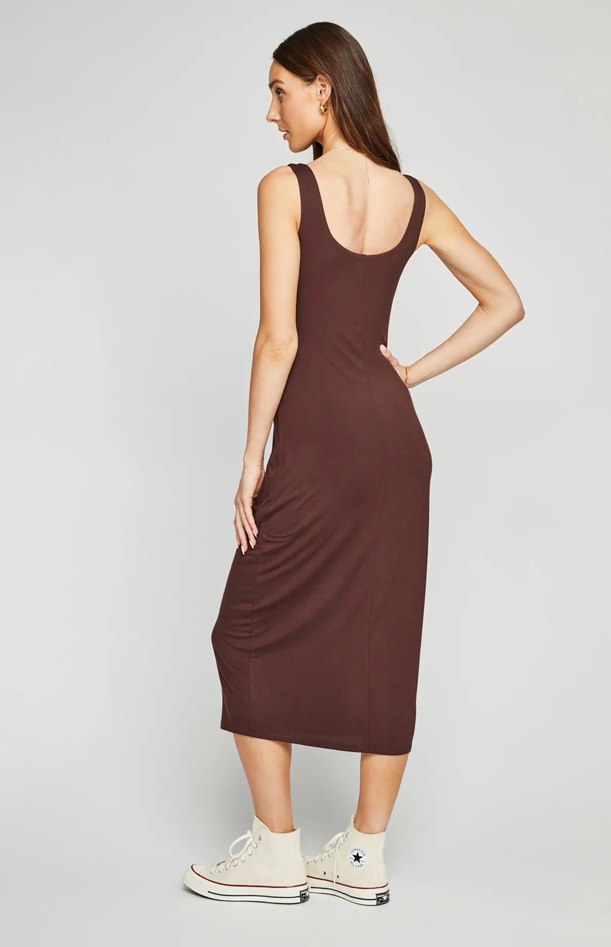 back view of woman wearing a brown, sleeveless midi dress