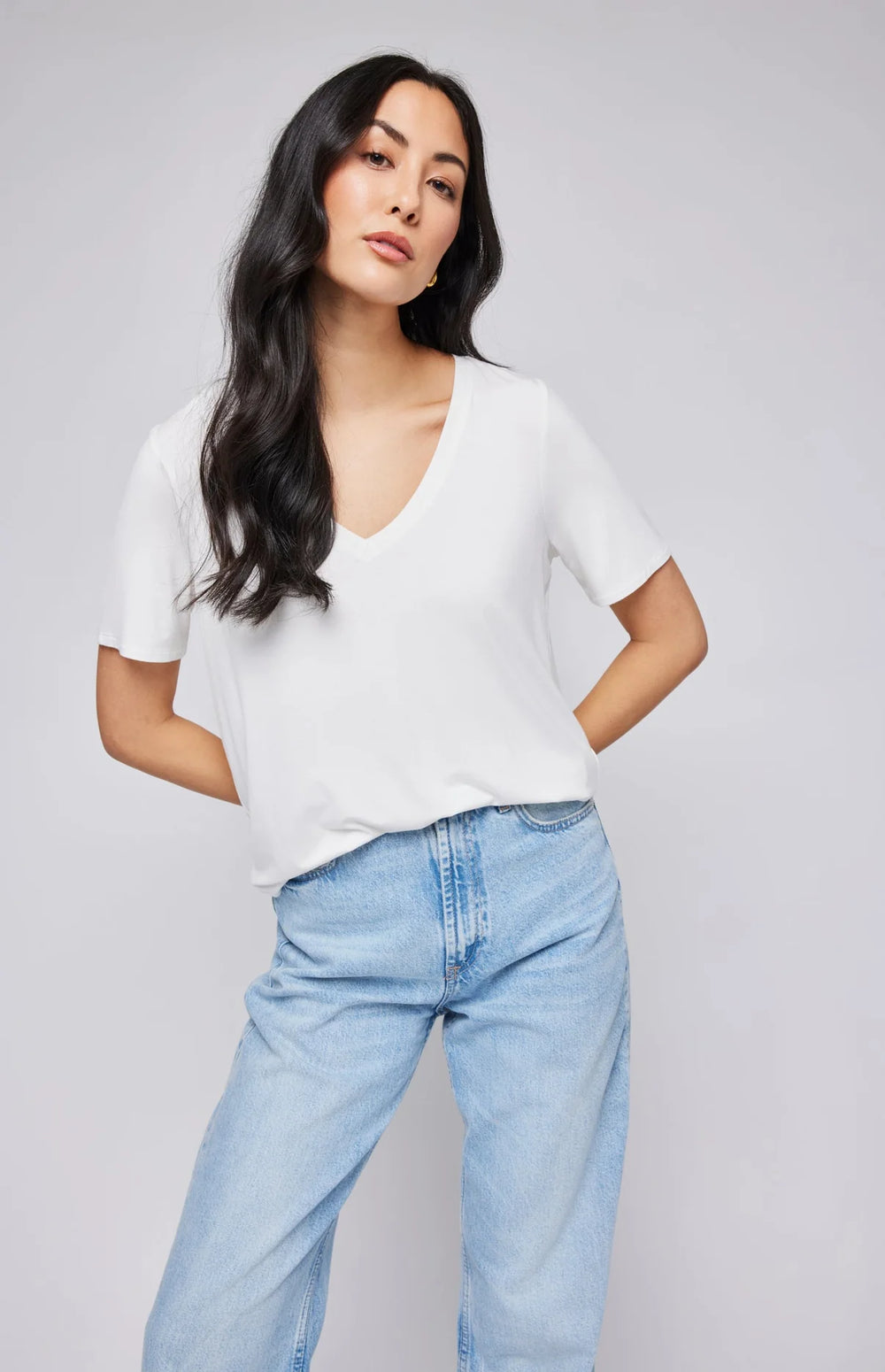 A woman wearing the relaxed fit Lewis Tee in the color White