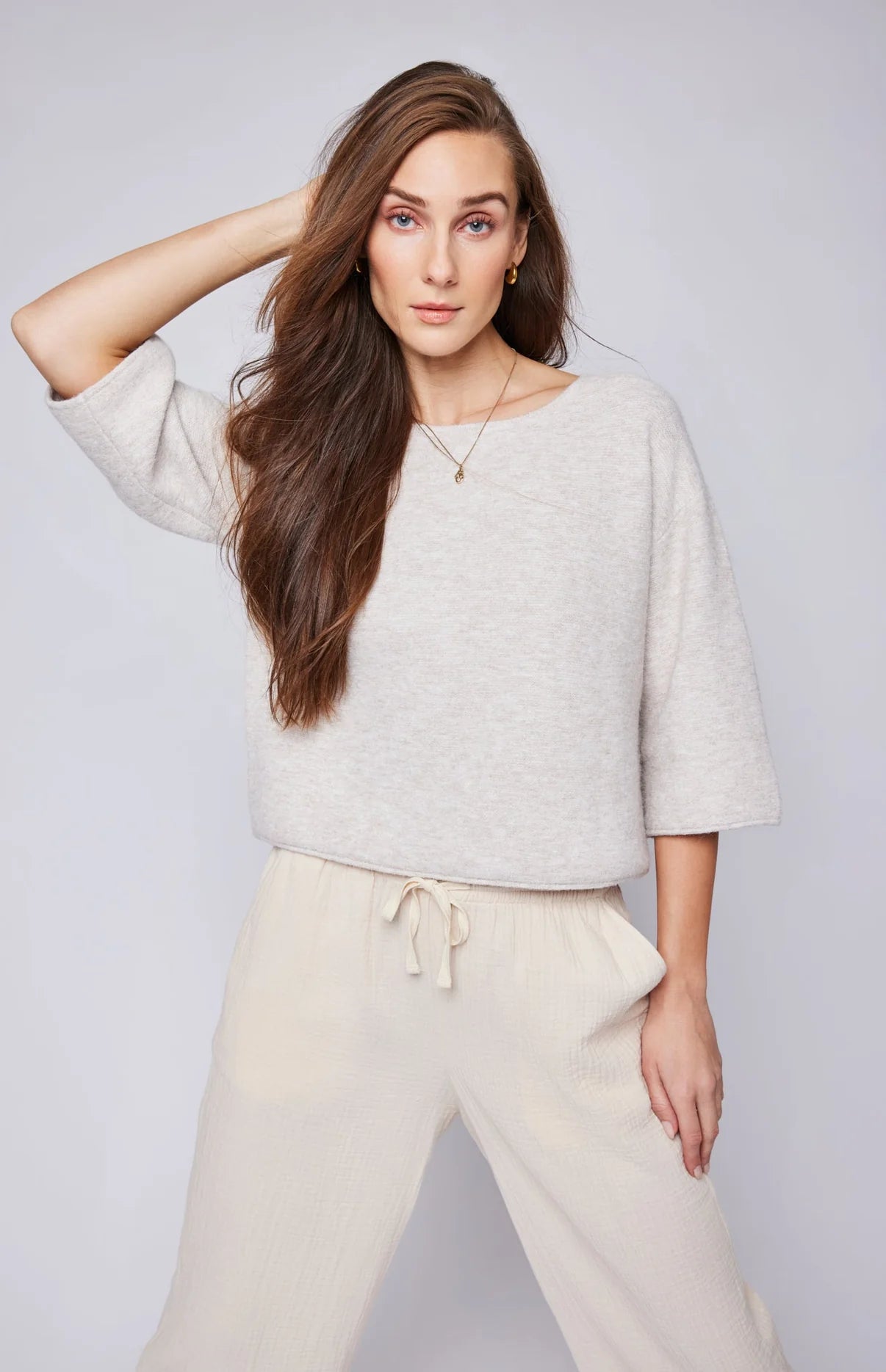 A woman wearing the Molly Pullover Sweater in the color Heather Oatmeal by Gentle Fawn