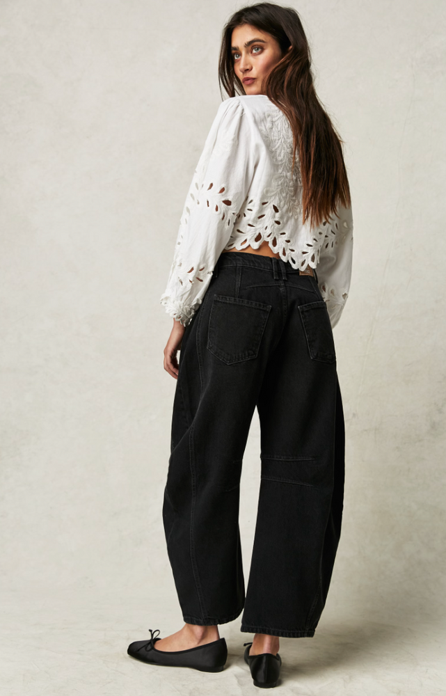 
                      
                        Back view of a woman wearing the Black Good Luck Mid-Rise Barrel Jeans by Free People
                      
                    