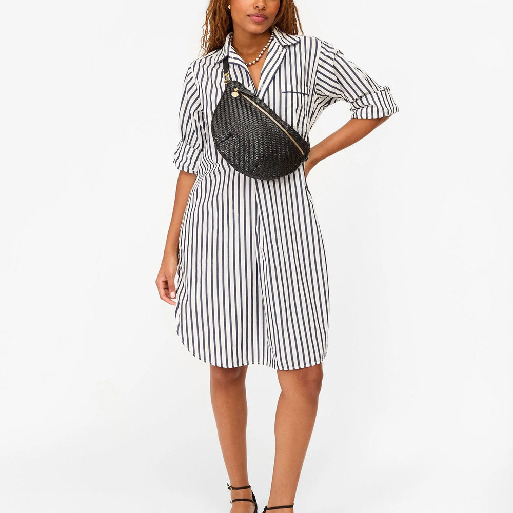 
                      
                        Woman wearing a black and white striped dress with a black crossbody bag from Clare V.
                      
                    
