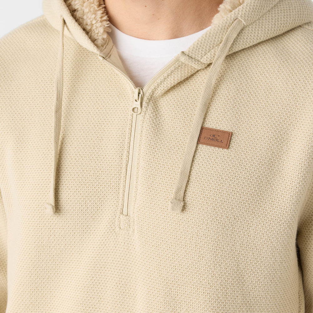 
                      
                        A man wearing the Light Khaki Passage Fleece Quarter Zip Pullover Hoodie by O'Neill with the hood down
                      
                    